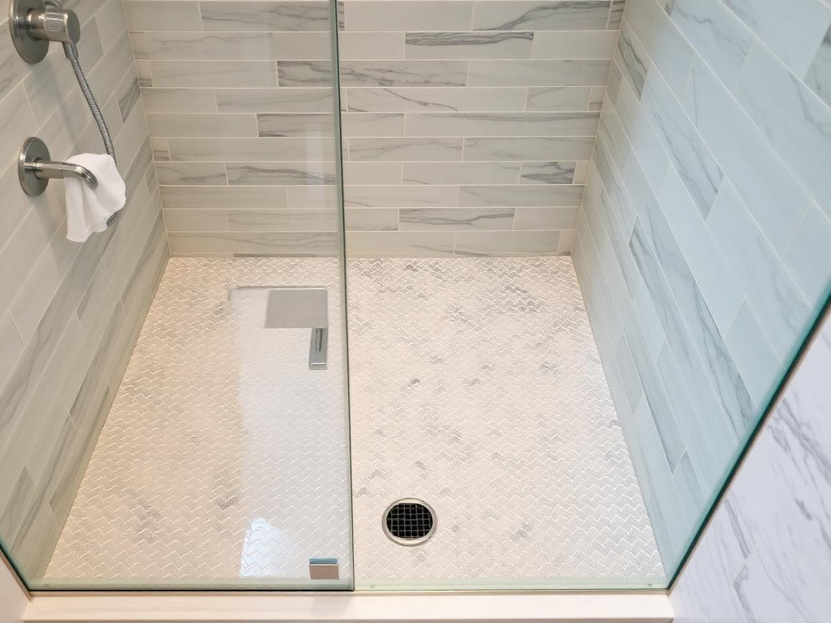 Custom tile shower with mosaic floor